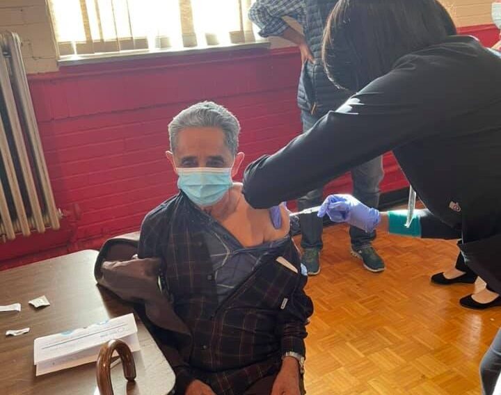 patient receives vaccine at international institute