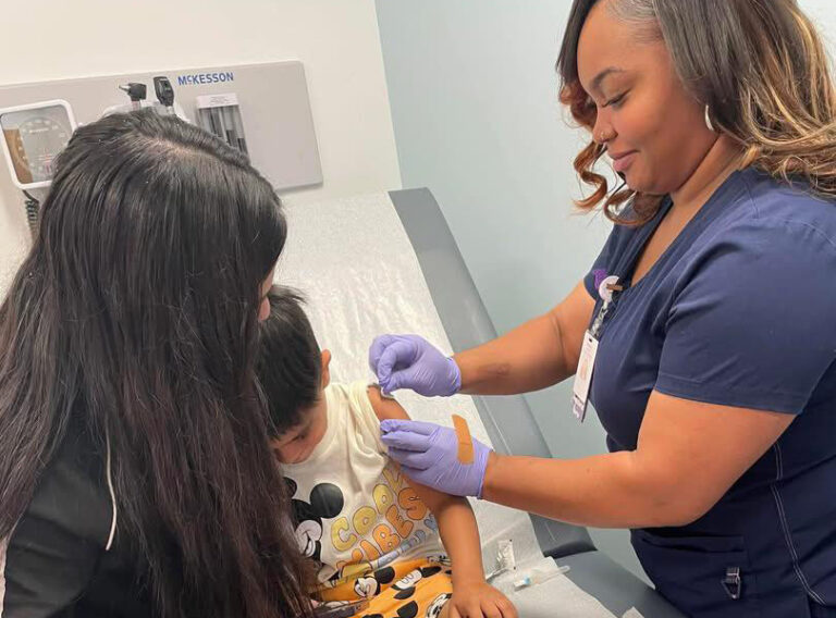nurse robinson gives child a shot